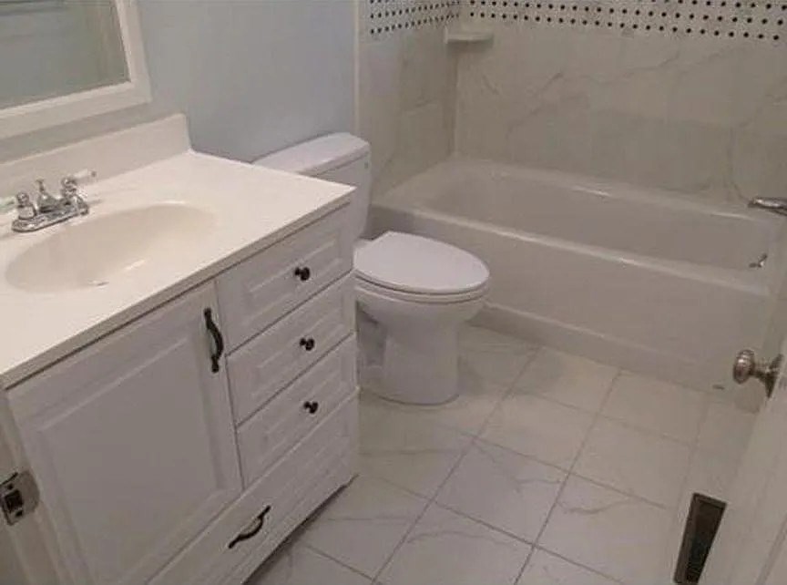 262 Brown Street, Unit 2 Waltham, MA 02453 - Photo 5 of 8 a bathroom with a sink a toilet and bathtub