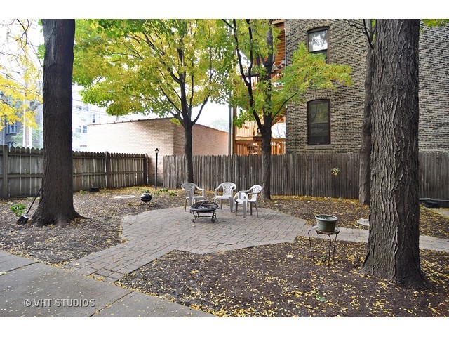 902 West Grace Street, Unit 1 Chicago, IL 60613 - Photo 11 of 11 a backyard of a house with table and chairs