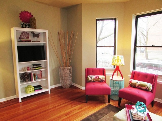 902 West Grace Street, Unit 1 Chicago, IL 60613 - Photo 4 of 11 a living room with furniture a flat screen tv and a floor to ceiling window