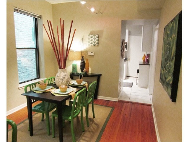 902 West Grace Street, Unit 1 Chicago, IL 60613 - Photo 6 of 11 a view of a dining room with furniture window and wooden floor
