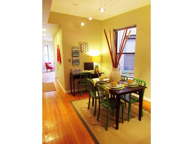 902 West Grace Street, Unit 1 Chicago, IL 60613 - Photo 7 of 11 a view of a dining room with furniture and a potted plant