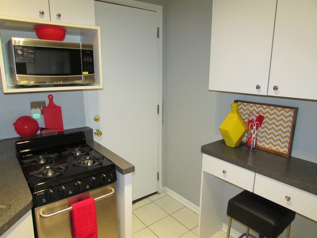 902 West Grace Street, Unit 1 Chicago, IL 60613 - Photo 9 of 11 a kitchen with a stove and a cabinet
