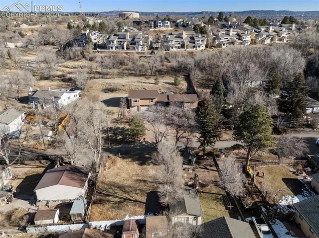 a view of parking space with large trees