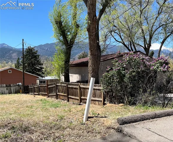 a view of a chairs and table in backyard