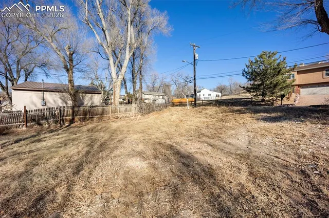 a view of street with wooden fence