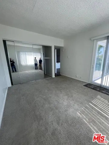 a view of a livingroom with an empty space and a window