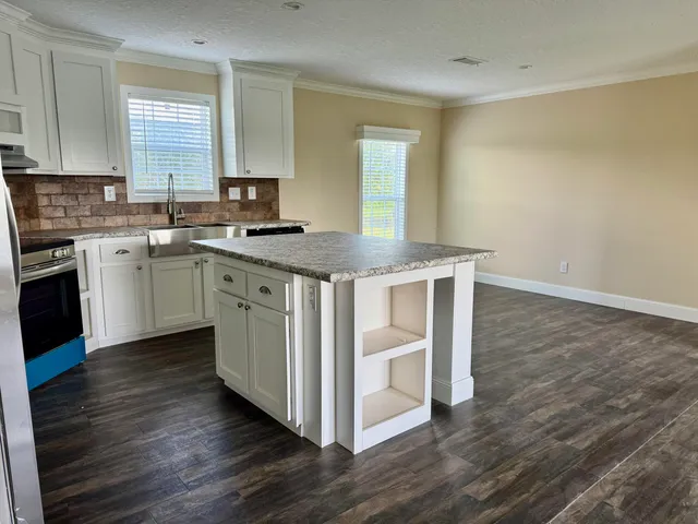 a kitchen with wooden floors and sink