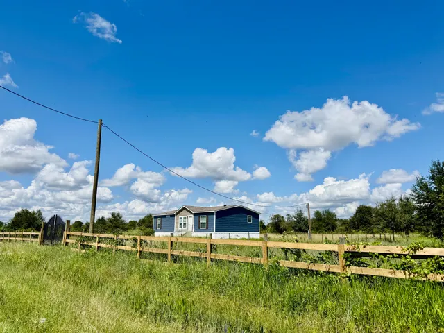 a view of a house with a big yard