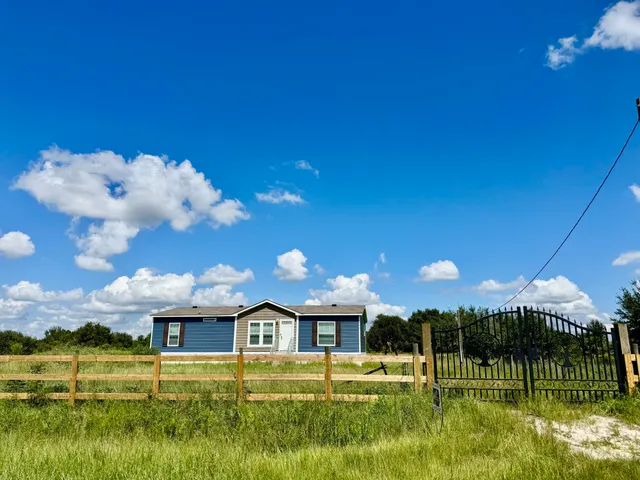 a view of a house with a big yard