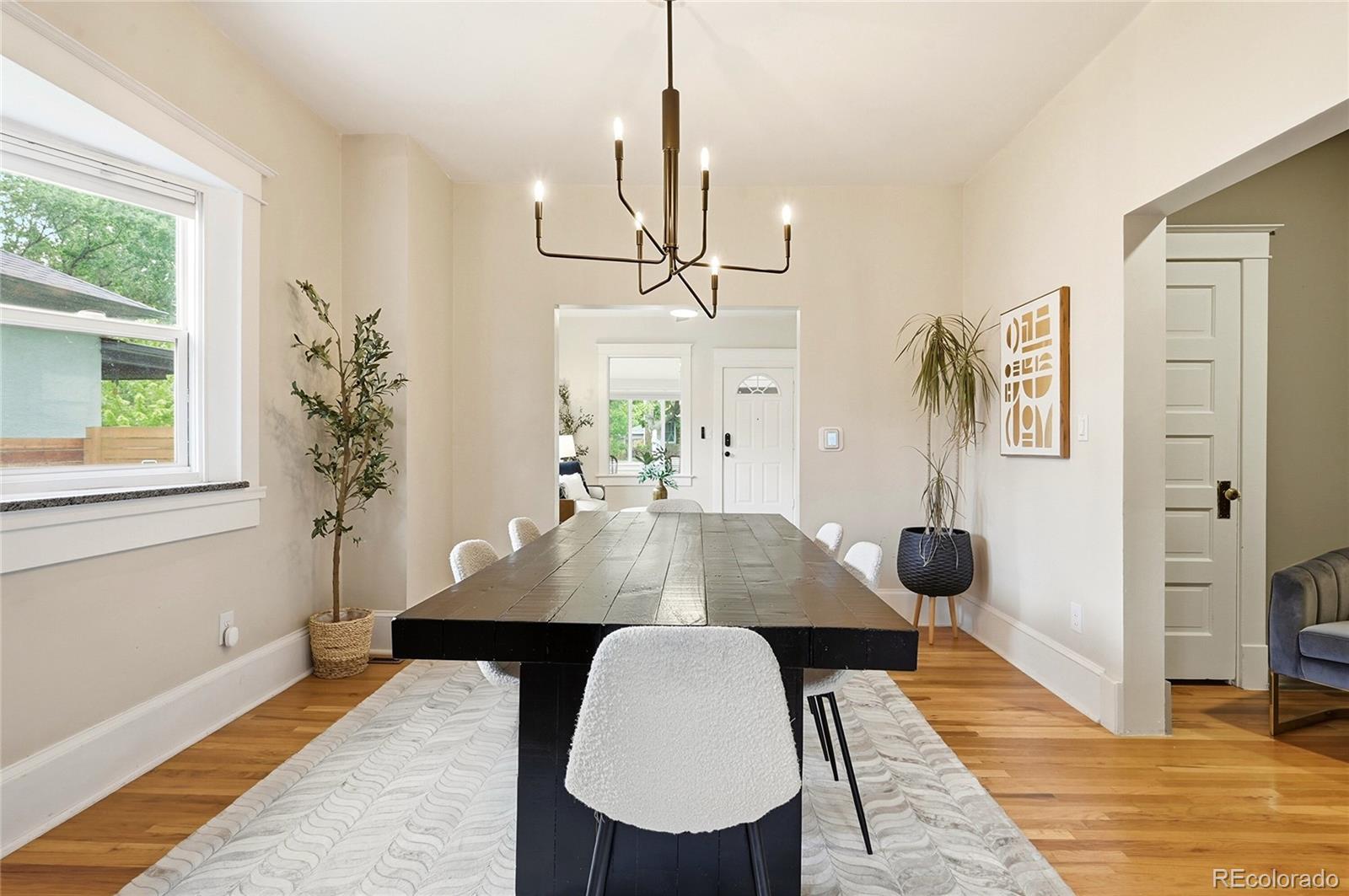 4546 Meade Street Denver, CO 80211 - Photo 11 of 35 a view of a dining room with furniture and wooden floor