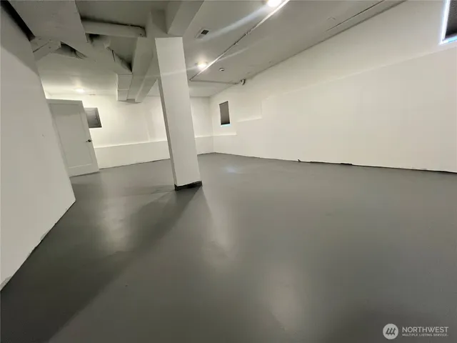 a view of a room with wooden floor and white walls