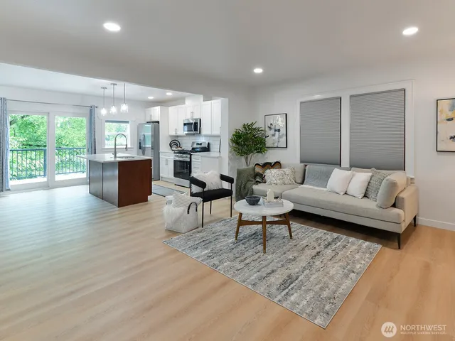 a living room with furniture and a wooden floor