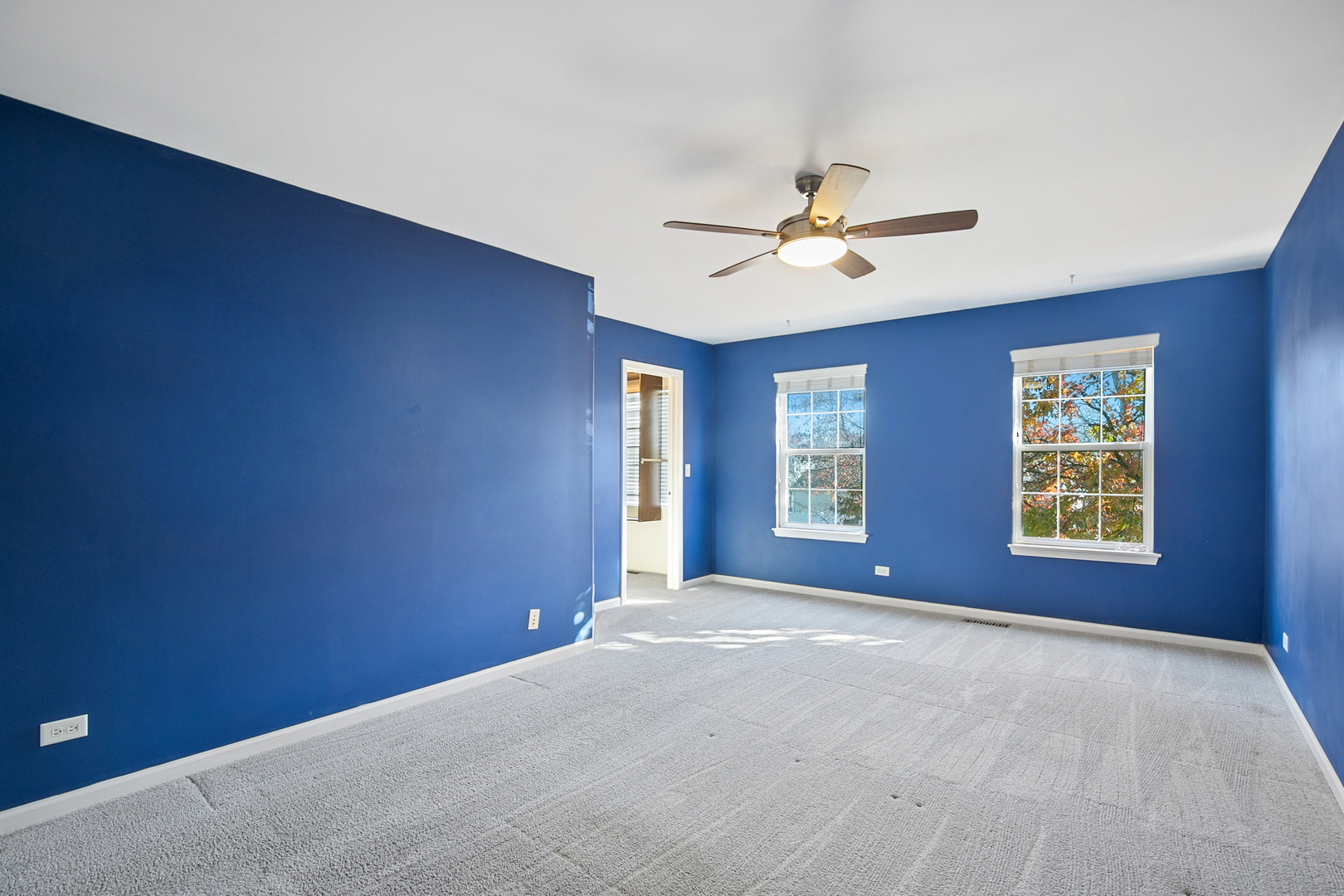 25904 Brooks Farm Road Round Lake, IL 60073 - Photo 11 of 20 a view of a big room with windows and chandelier fan