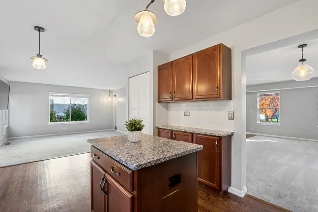 a kitchen with granite countertop cabinets stove and microwave