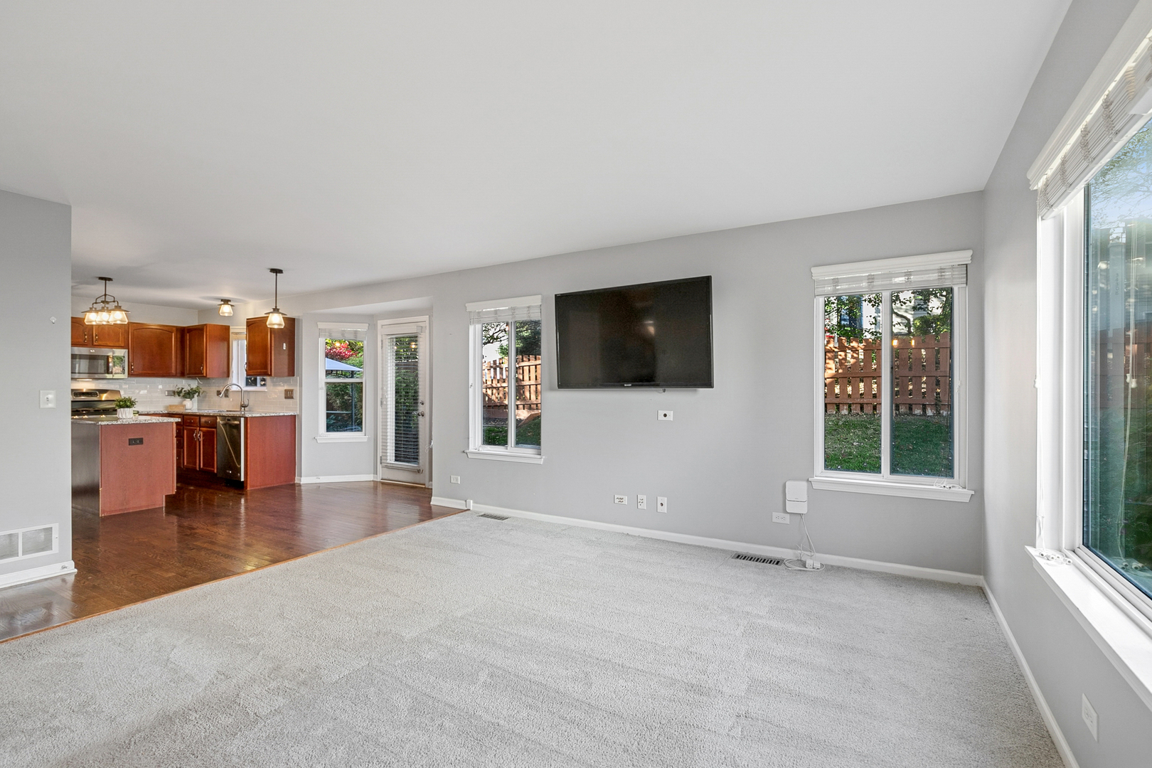 25904 Brooks Farm Road Round Lake, IL 60073 - Photo 8 of 20 a view of a livingroom with furniture wooden floor and a floor to ceiling window