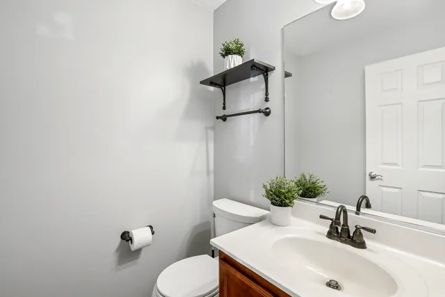 a bathroom with a sink toilet and a mirror