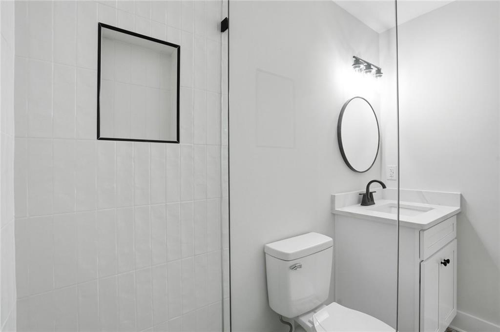 134 Henry Meyer Road Winterville, GA 30683 - Photo 23 of 34 a bathroom with a toilet sink vanity and mirror