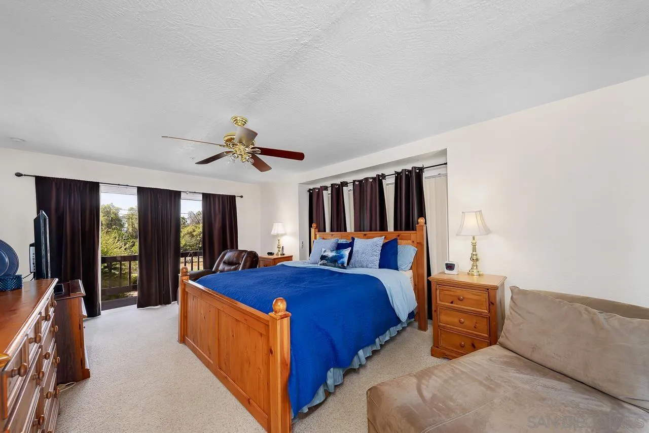 719 Singing Trails Drive El Cajon, CA 92019 - Photo 18 of 73 a bed room with a bed and a chandelier