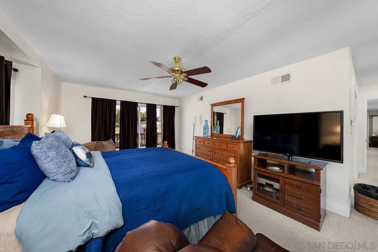 719 Singing Trails Drive El Cajon, CA 92019 - Photo 20 of 73 a bedroom with a bed and a flat screen tv