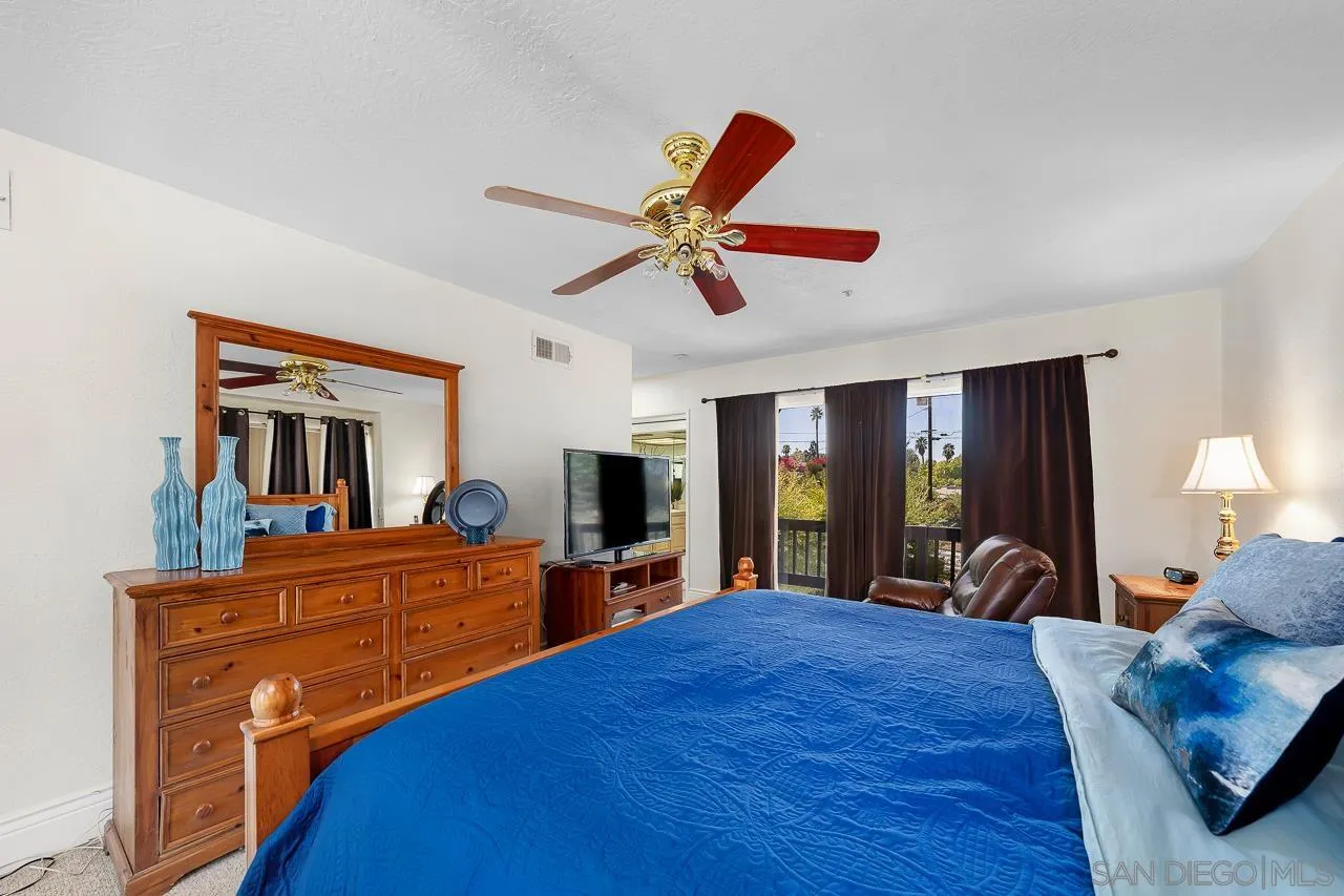 719 Singing Trails Drive El Cajon, CA 92019 - Photo 21 of 73 a bedroom with a bed and a large dresser next to a window