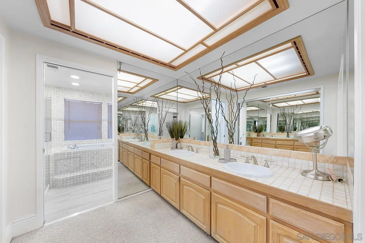 719 Singing Trails Drive El Cajon, CA 92019 - Photo 23 of 73 a bathroom with a granite countertop sink mirror and