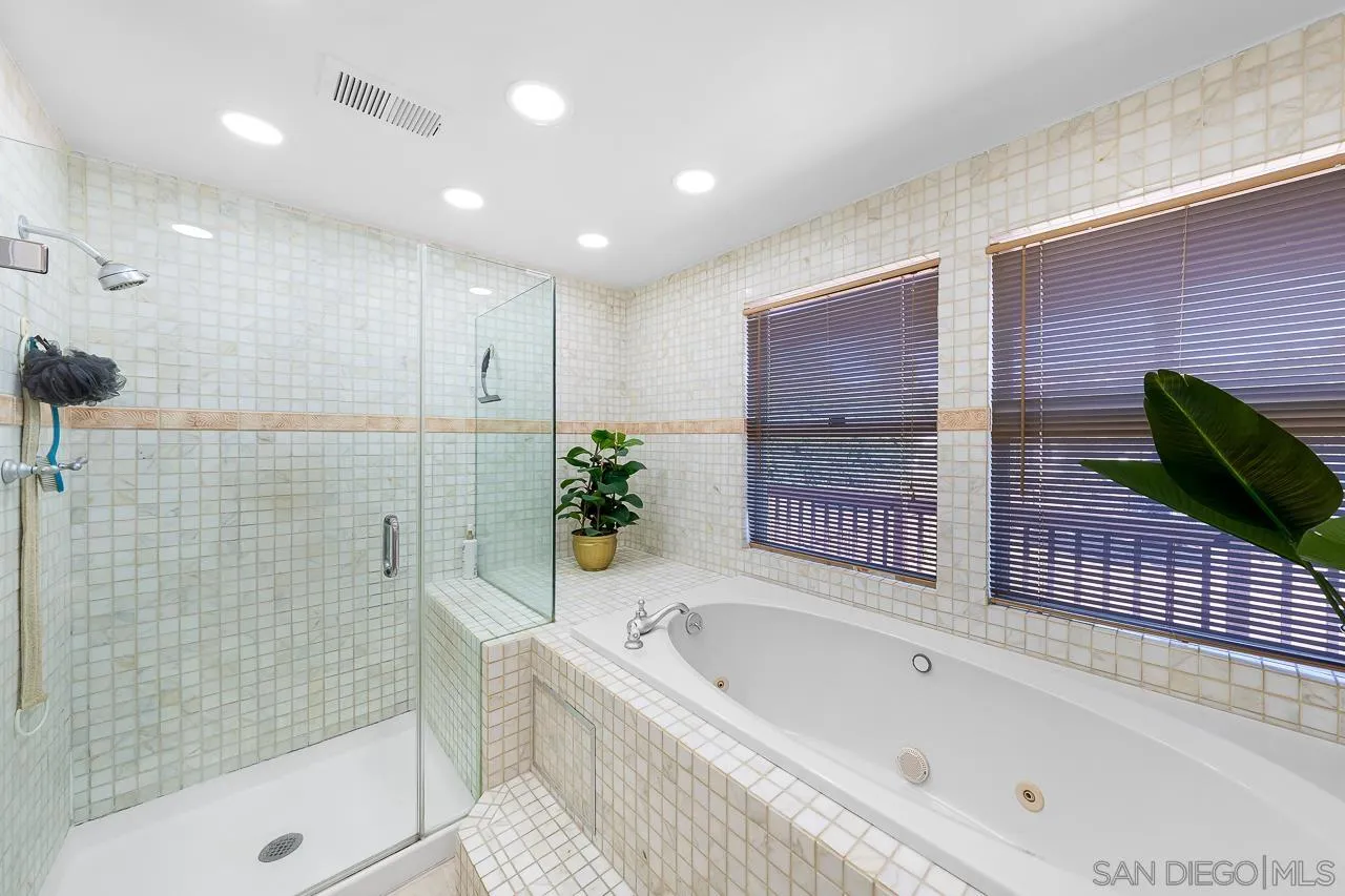 719 Singing Trails Drive El Cajon, CA 92019 - Photo 25 of 73 a bathroom with a tub shower and sink