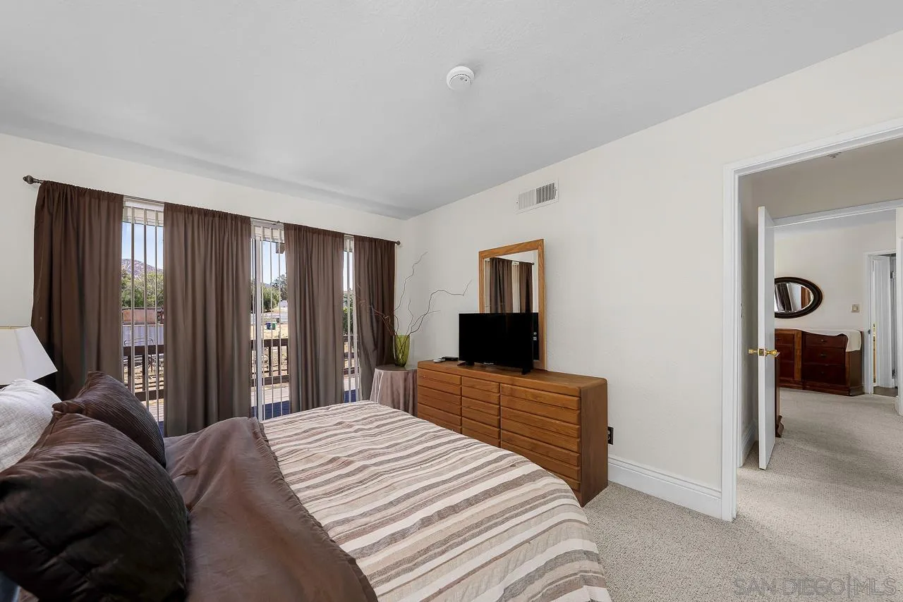 719 Singing Trails Drive El Cajon, CA 92019 - Photo 29 of 73 a bedroom with a bed and a television