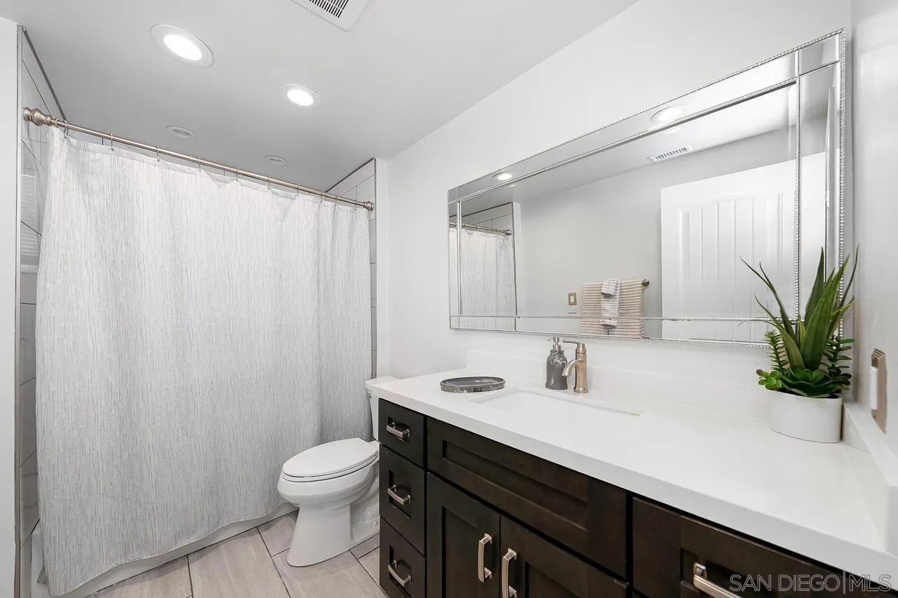 719 Singing Trails Drive El Cajon, CA 92019 - Photo 30 of 73 a bathroom with a sink a toilet and a mirror