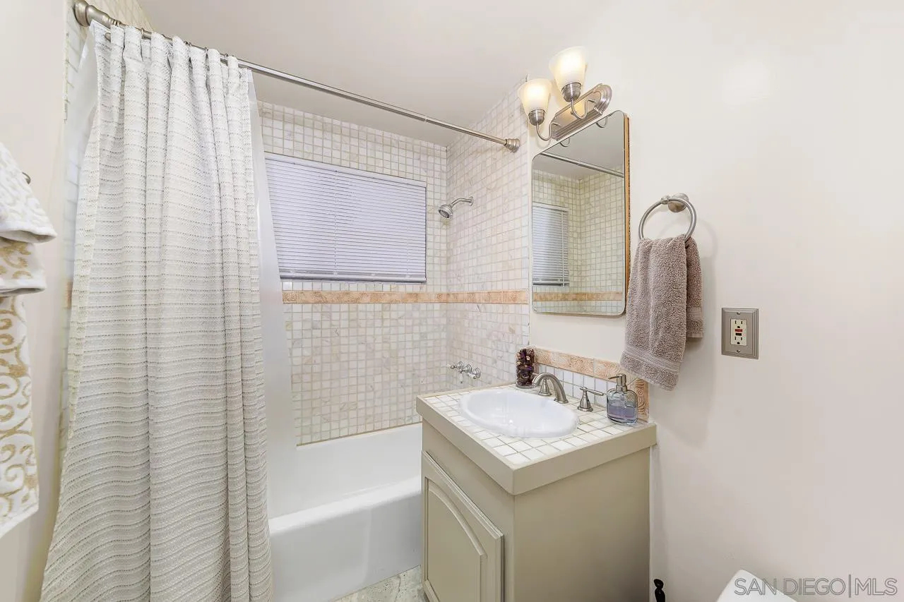 719 Singing Trails Drive El Cajon, CA 92019 - Photo 39 of 73 a bathroom with a sink a vanity and a mirror