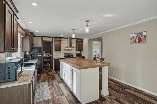 a kitchen with stainless steel appliances granite countertop a stove and a refrigerator