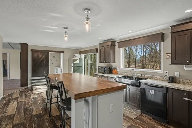a kitchen with sink a center island and cabinets