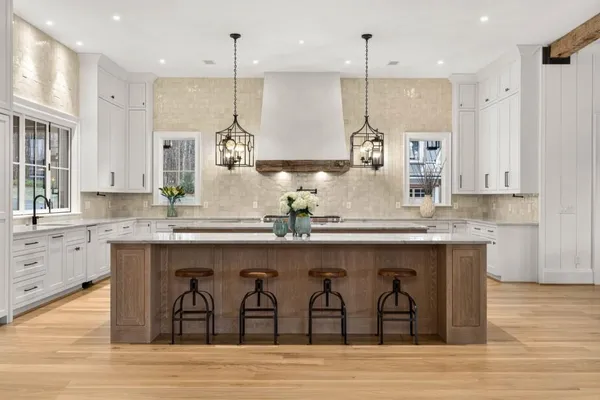 a kitchen with stainless steel appliances granite countertop a sink a oven a counter top space and living room view