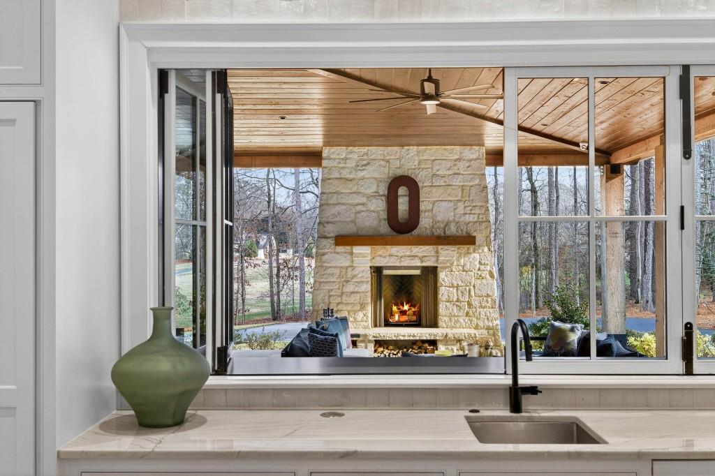 1050 Hamilton Road Northwest Kennesaw, GA 30152 - Photo 18 of 72 a living room with a fireplace and potted plant