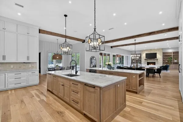 a kitchen with stainless steel appliances granite countertop a stove and a refrigerator with cabinets