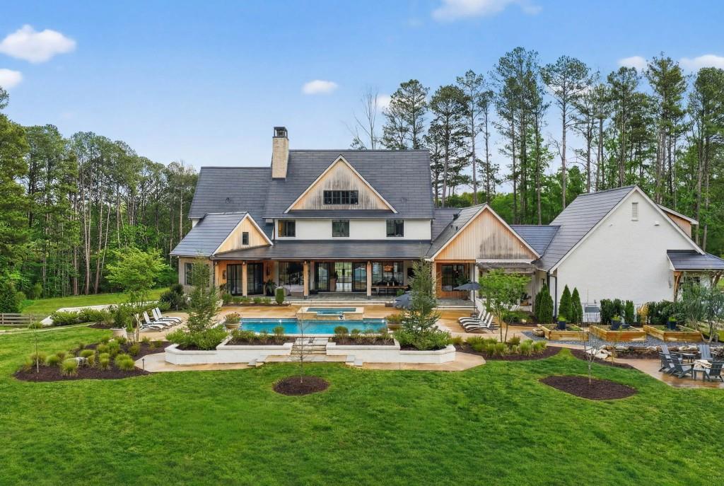1050 Hamilton Road Northwest Kennesaw, GA 30152 - Photo 26 of 72 a front view of a house with swimming pool having outdoor seating