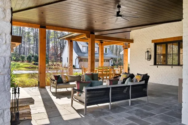 a living room with furniture a flat screen tv and a fireplace