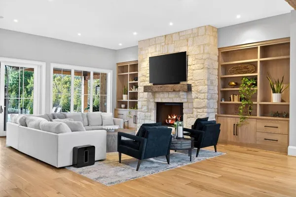 a living room with furniture fireplace and flat screen tv