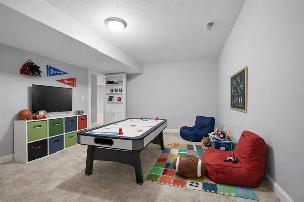 a reading room with furniture and a flat screen tv