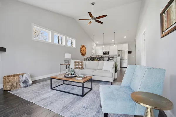 a living room with furniture and a wooden floor