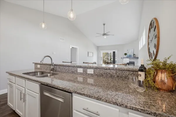 a kitchen with sink and a granite counter top