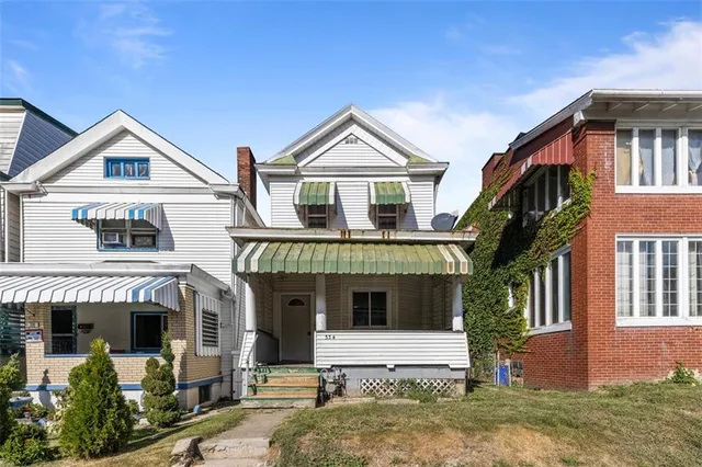 a front view of a house with garden