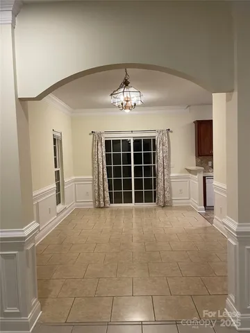 a view of a livingroom with a chandelier and a window