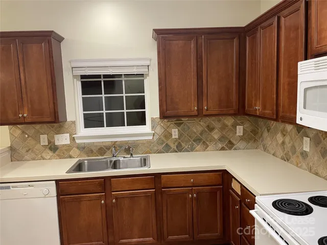 a kitchen with a sink cabinets and window