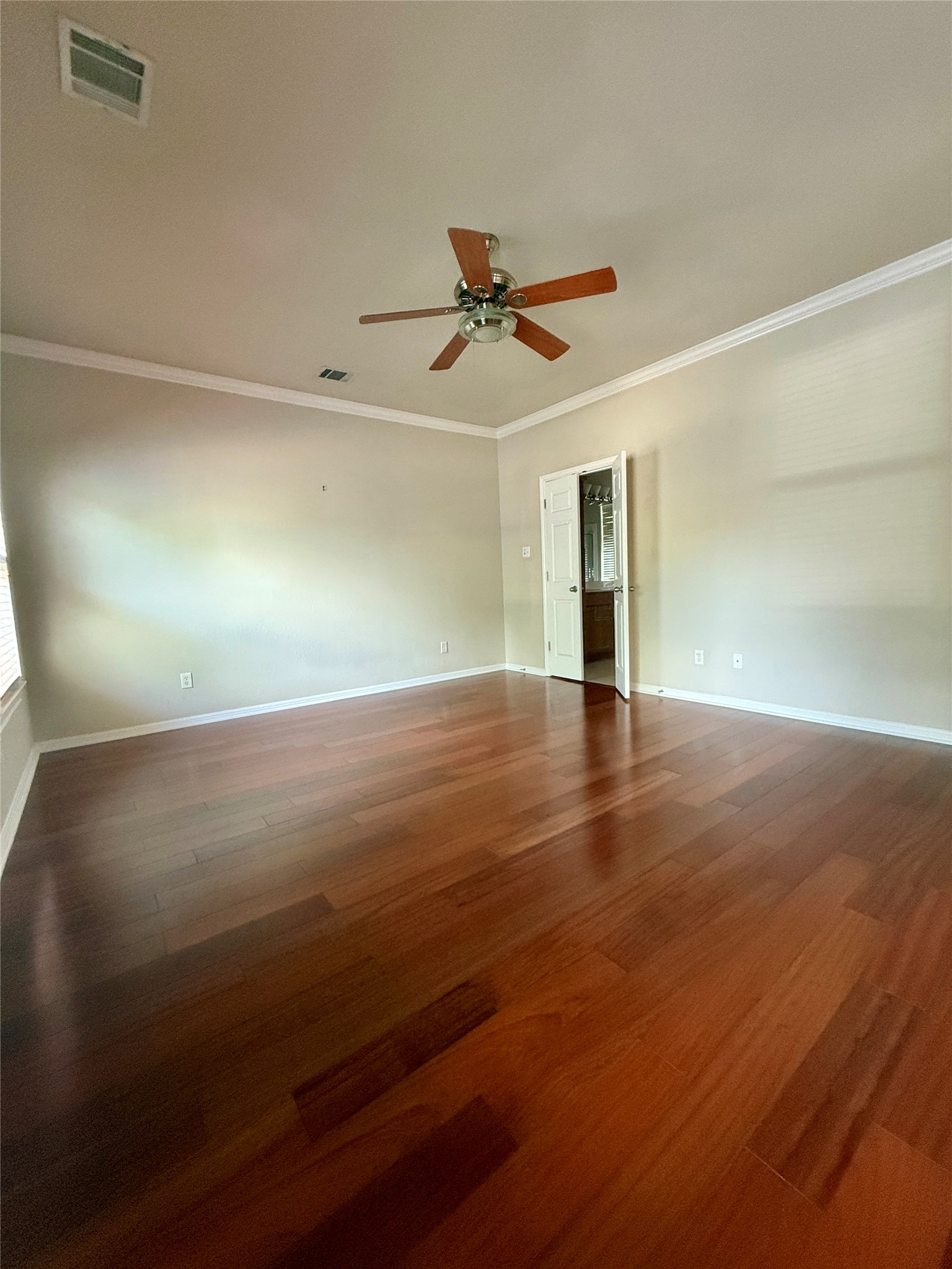 411 West St Elmo Road, Unit 39 Austin, TX 78745 - Photo 6 of 25 primary bedroom is oversized and has warm wood floors, en suite bathroom with walk-in closet, and secondary closet in bedroom