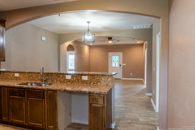 a view of livingroom with hardwood floor and a ceiling fan