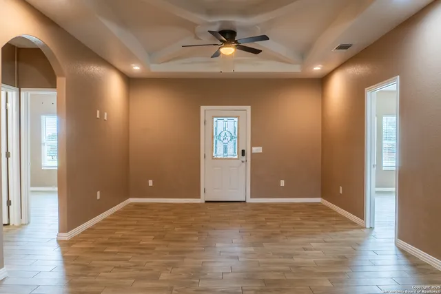 a kitchen with granite countertop a refrigerator stove and cabinets