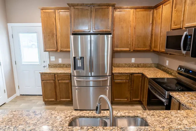 a kitchen with a refrigerator stove and sink
