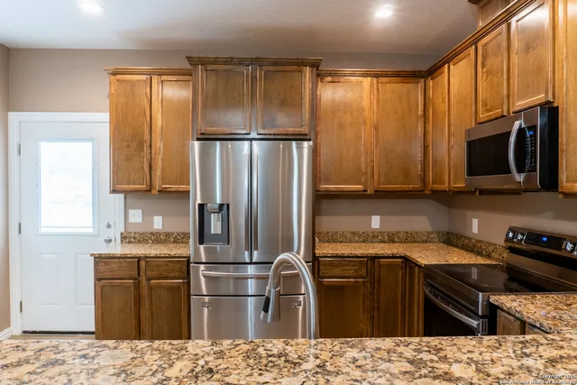 a kitchen with a refrigerator stove and microwave
