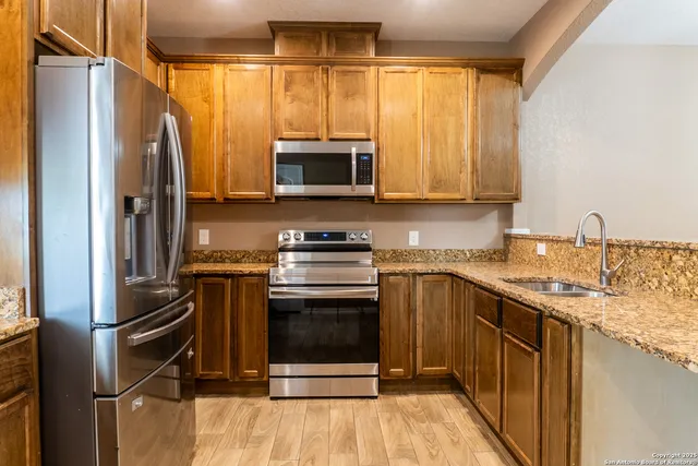 a kitchen with granite countertop stainless steel appliances and cabinets