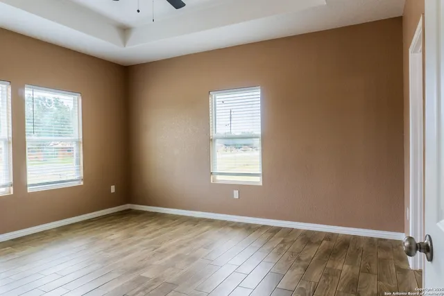 a bathroom with a granite countertop sink toilet and mirror